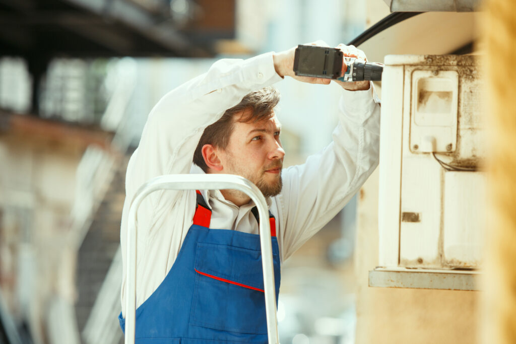 hvac-technician-working-capacitor-part-condensing-unit-1024x683